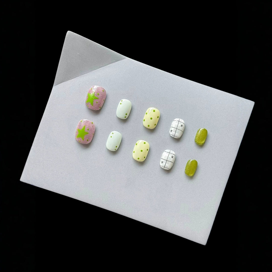 Playful Press-On Nail Art Set with Fun Patterns and Glitter Accents