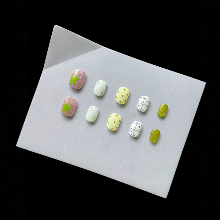 Playful Press-On Nail Art Set with Fun Patterns and Glitter Accents