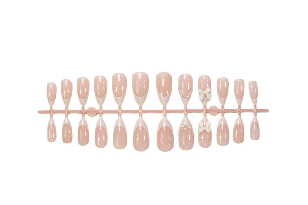 Acrylic nail set with elegant floral embellishments and trendy French tip Stornfield
