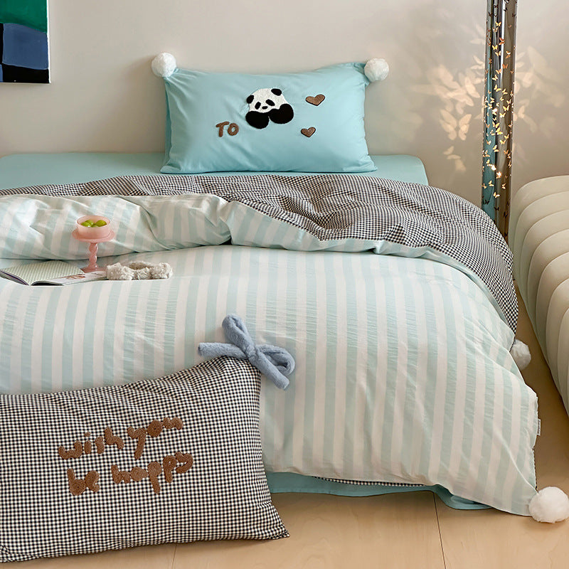 Children's bedding set with striped duvet cover, checkered decorative pillow, and plush application