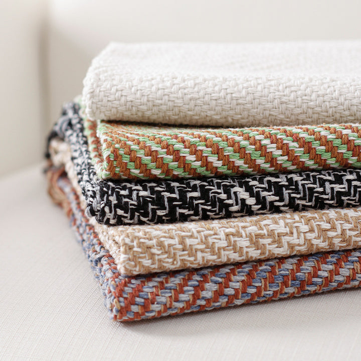 Handwoven table runner in herringbone pattern with decorative fringes