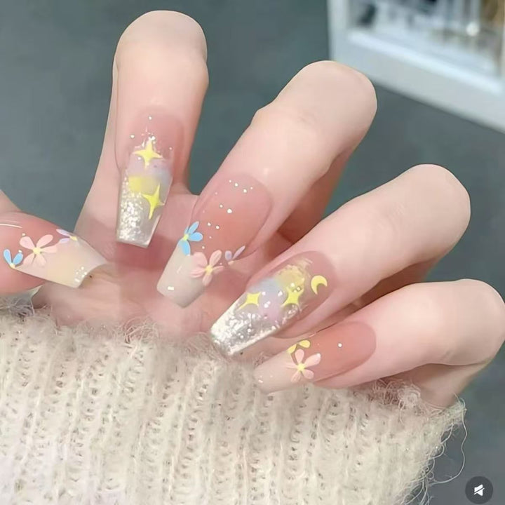 Artificial nails with delicate floral accents and glitter effects Stornfield