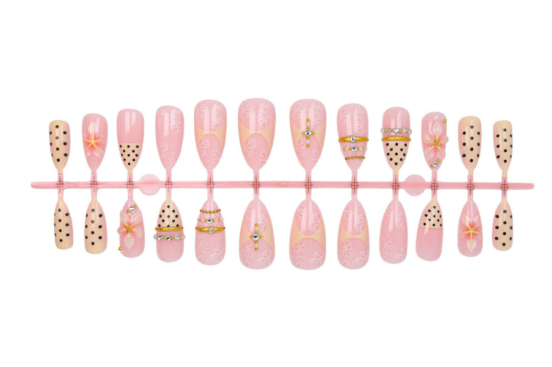 Artificial nail set with delicate floral patterns and elegant accents Stornfield