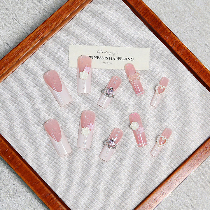 Artful nail tips with pearl and bow motifs Stornfield