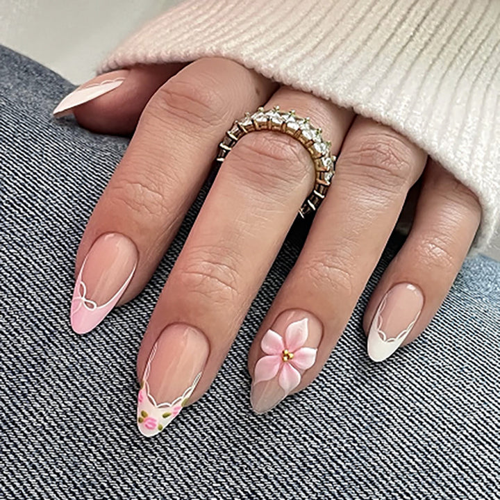 Artful nail extensions with delicate floral pattern and elegant accents Stornfield