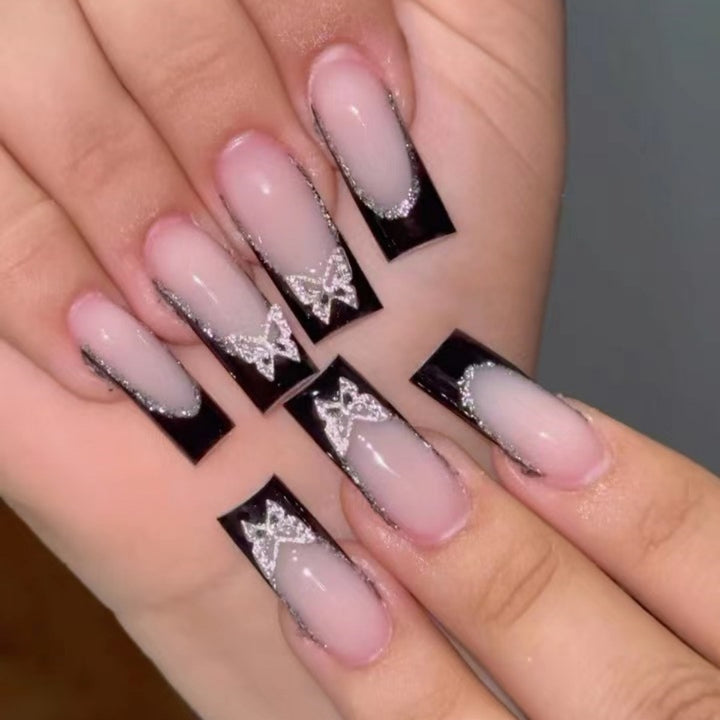 Glamorous Stiletto Nail Extensions with Butterfly Accents Stornfield