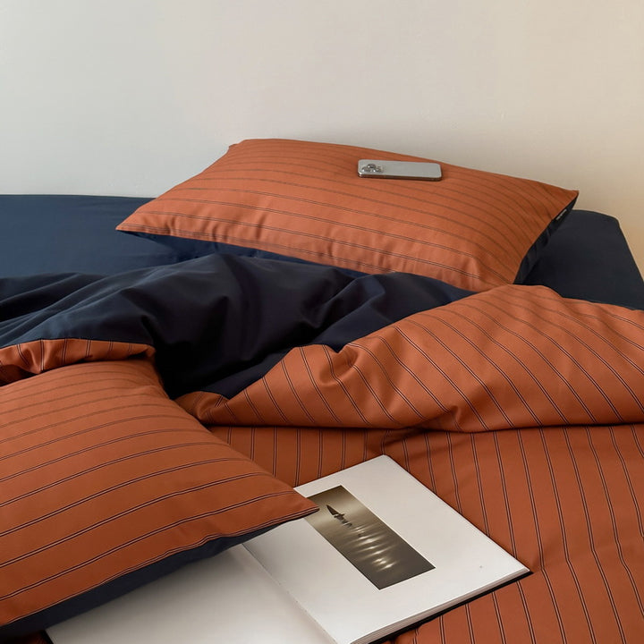 Reversible cotton satin bedding set with fine striped pattern and contrasting backside