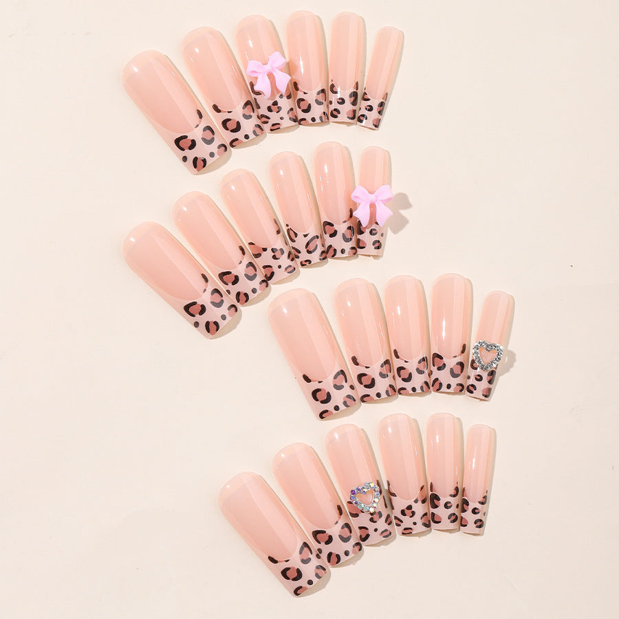 Creative nail set with leopard pattern and bow accents Stornfield