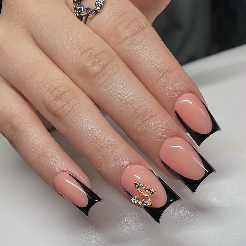 Artificial nails with elegant black and white tips and delicate accents Stornfield