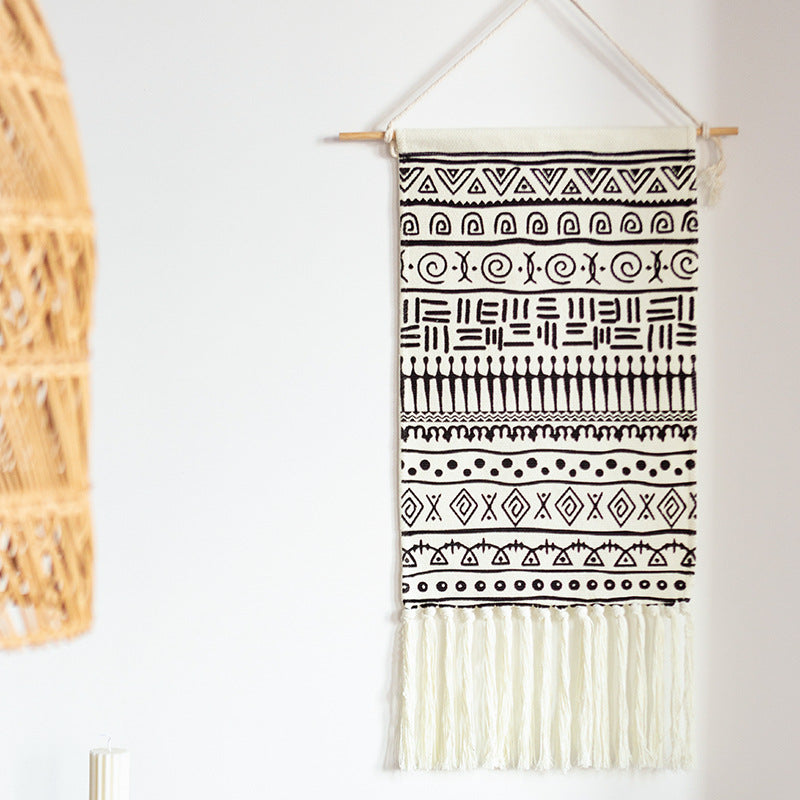 Woven cotton blend wall hanging with graphic ethnic pattern and long fringes Stornfield