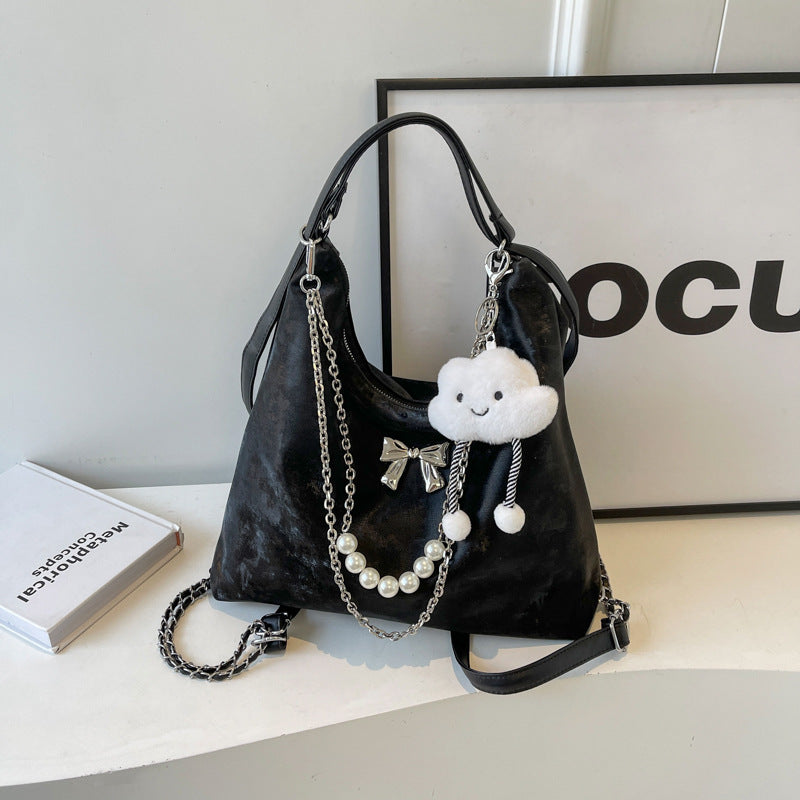 Fashionable handbag with unique pendant and chain accents Stornfield