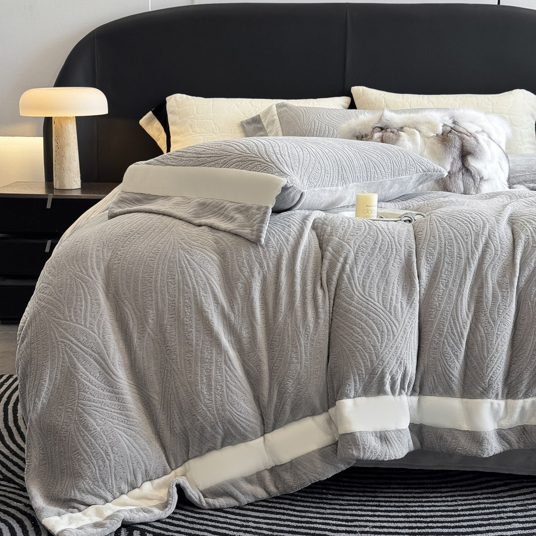Quilted bedding set made of cotton blend with raised leaf texture and contrasting border
