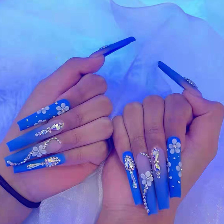 Nail art set with elegant 3D flower designs and glitter accents Stornfield