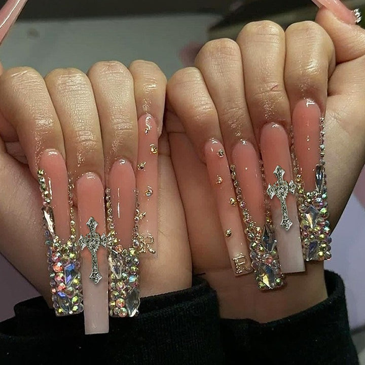 Glamorous artificial nail set with sparkling rhinestones and cross decorations Stornfield