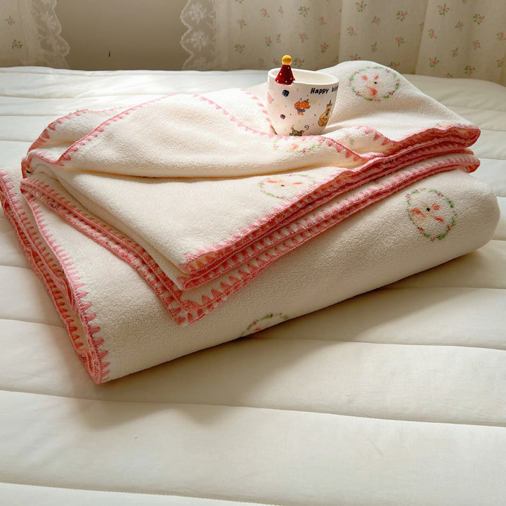 Microfleece cuddly blanket with polka dot pattern and decorative overlock seam