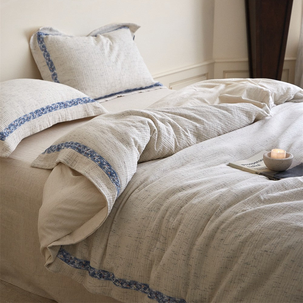 Linen bedding set with woven texture and subtle indigo border