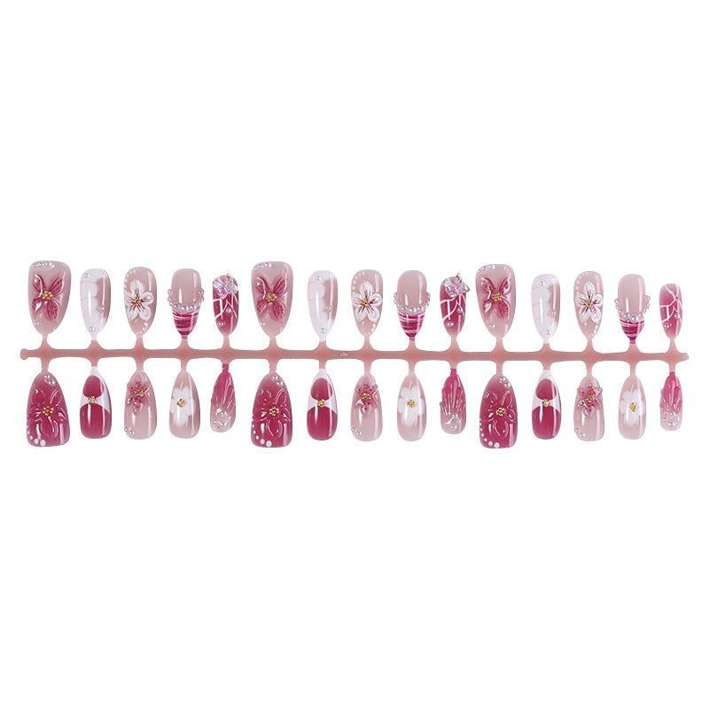 Creative acrylic nail set with floral accents and glitter decorations Stornfield