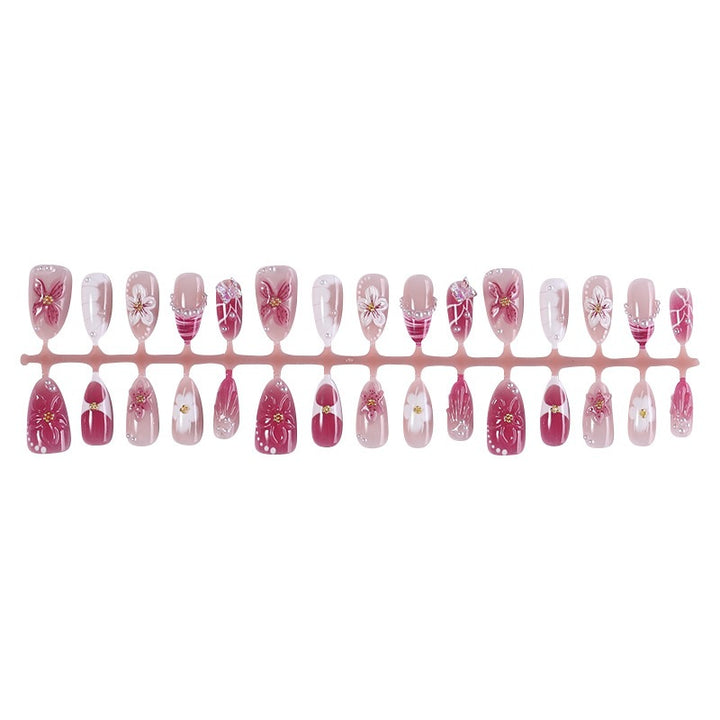 Creative acrylic nail set with floral accents and glitter decorations Stornfield