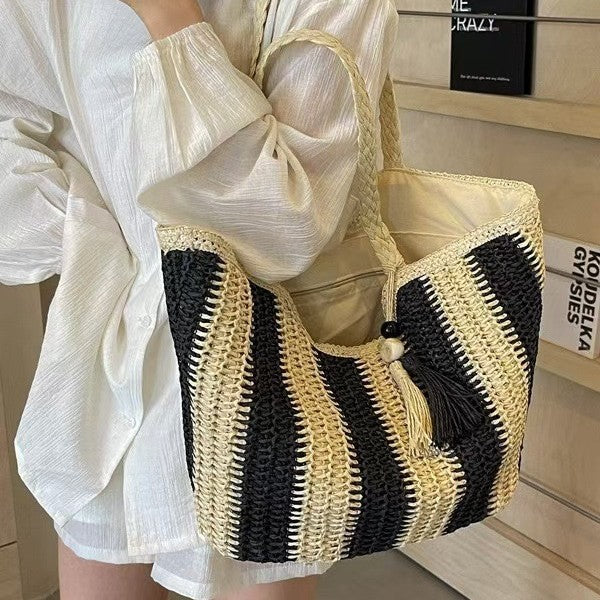 Handcrafted straw bag with elegant tassels and detailed texture Stornfield
