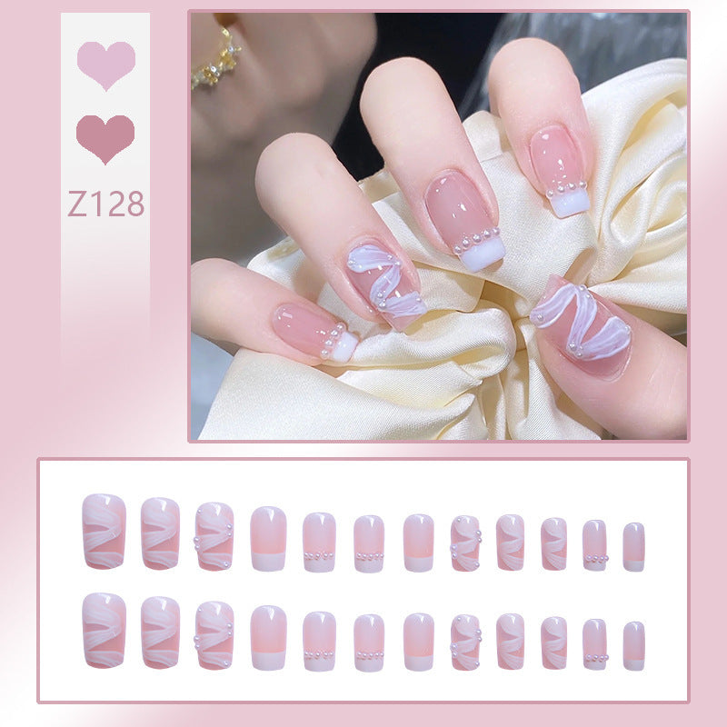 Nail art set with elegant wave patterns and delicate pearl accents Stornfield