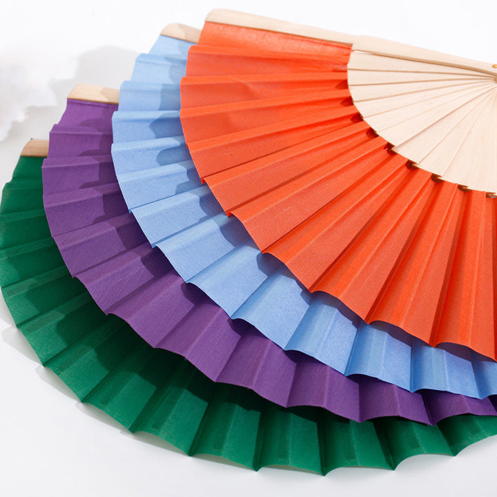 Ladies folding hand fan made of airy material with intricate folds Stornfield