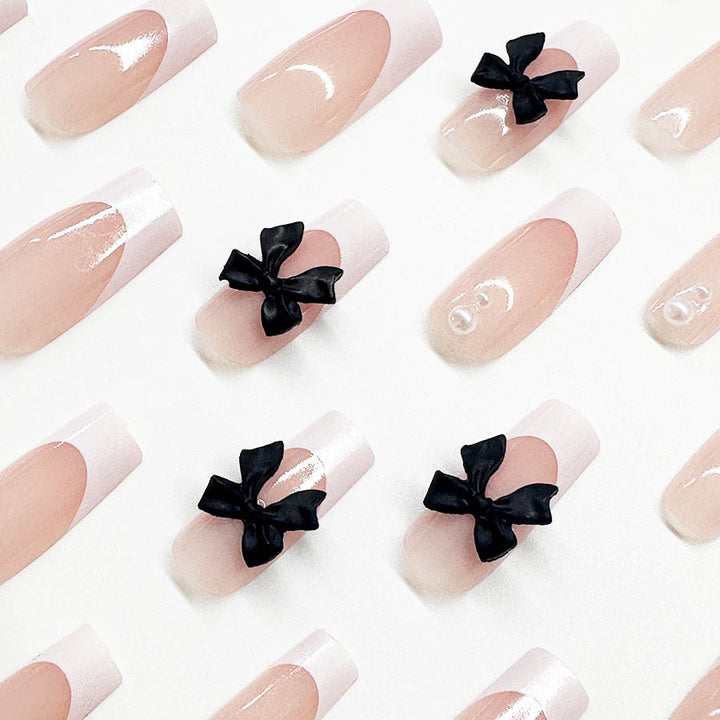 Acrylic nail set with stylish black and pearl details Stornfield