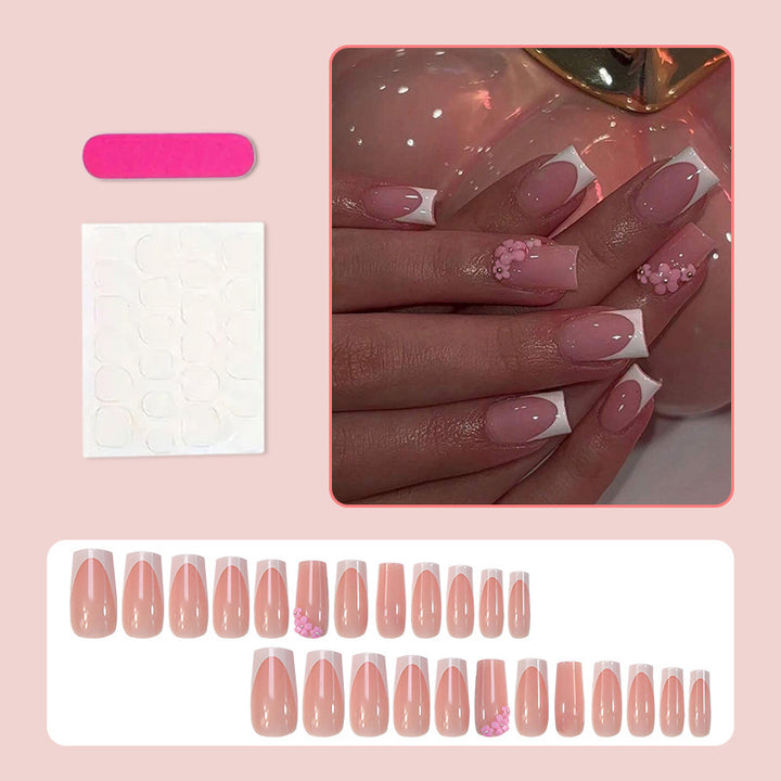 Acrylic nail set with elegant French tips and decorative accents Stornfield