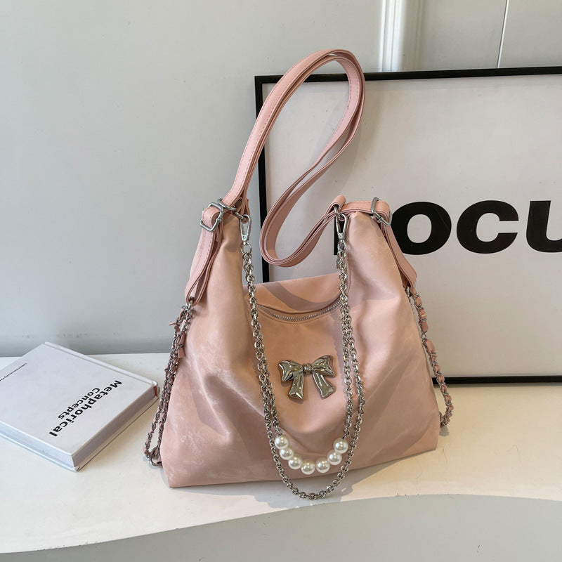 Fashionable handbag with unique pendant and chain accents Stornfield