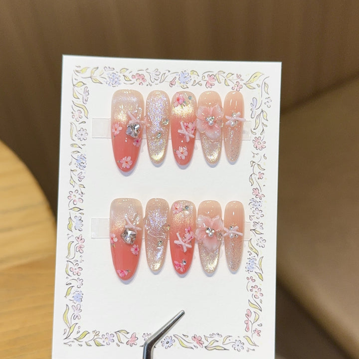 Artificial nails with floral embellishments and glitter effects Stornfield