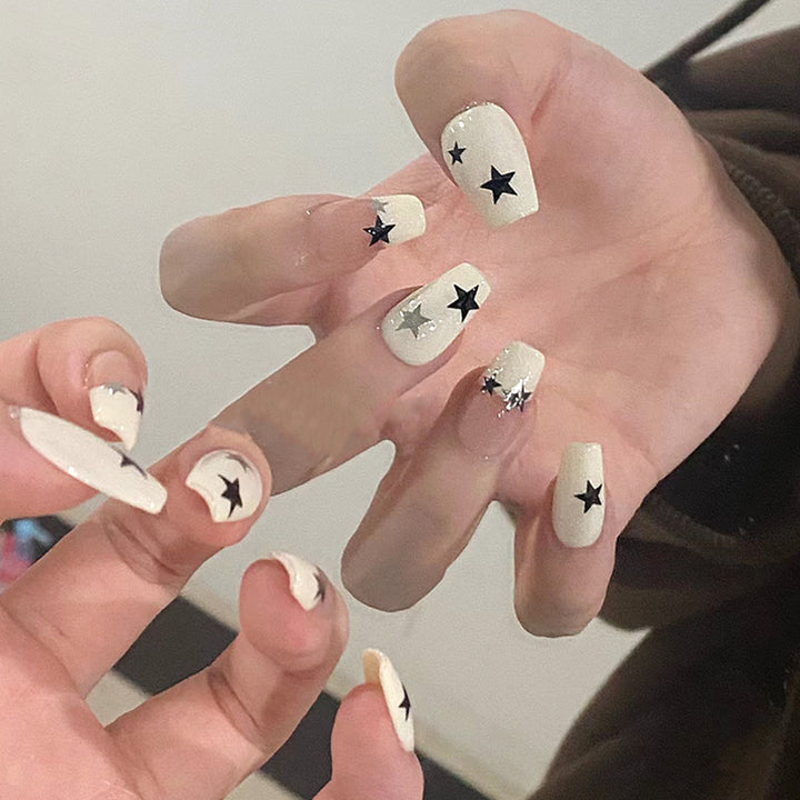 Artificial nail set with glamorous star design and sparkling accents Stornfield