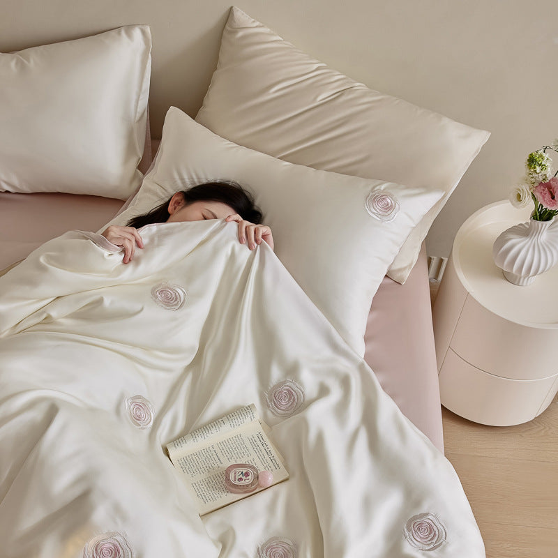 Luxurious satin bedding set with floral embroidered rose details and reversible function