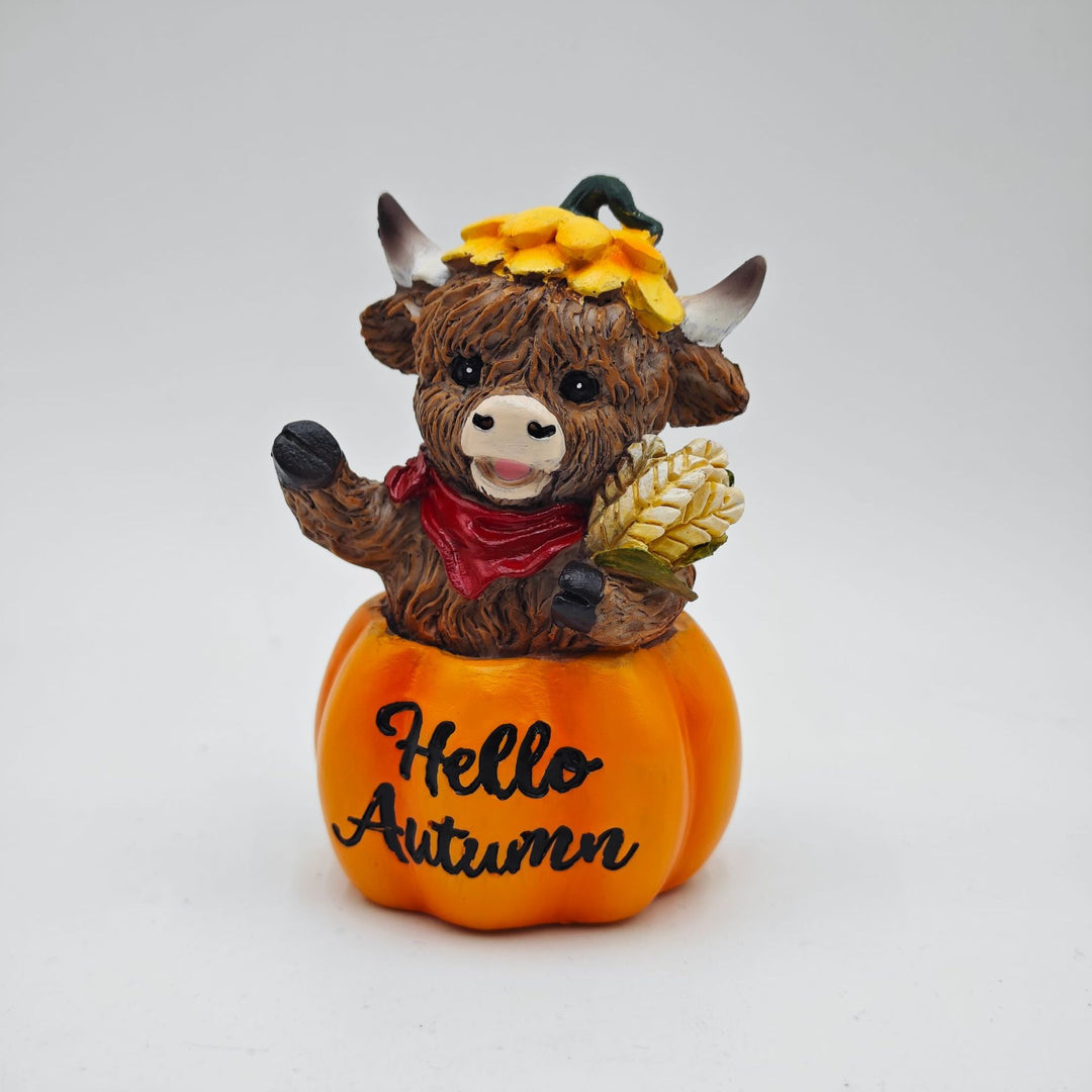 Funny decorative figure of a Highland cow in pumpkin costume Stornfield