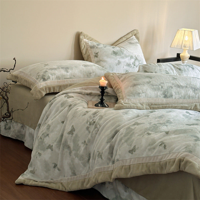 Luxurious quilted bedding set with velvet trim and floral branch motif