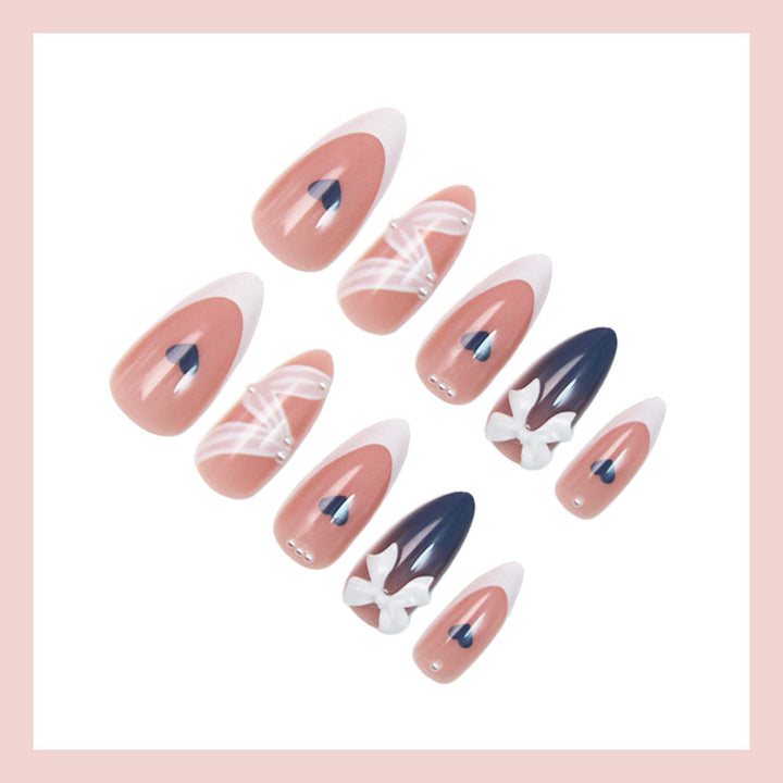 Artificial nail set with elegant bows and heart-shaped accents Stornfield