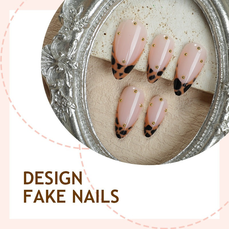 Acrylic nail set with elegant leopard design and gold accents Stornfield