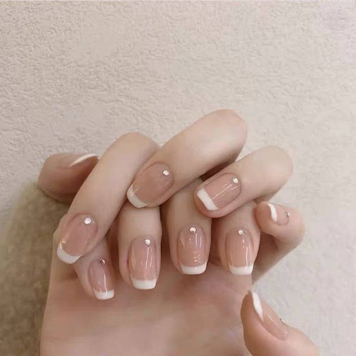 Artificial nails with elegant French tip and rhinestone accents Stornfield