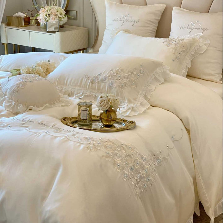 Romantic cotton satin bedding set with ruffles, floral embroidery, and satin bows