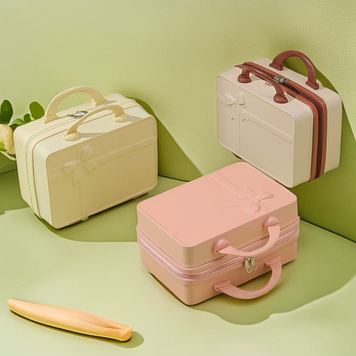 structured hard-shell cosmetic travel case with embossed bow and dual top handles Stornfield