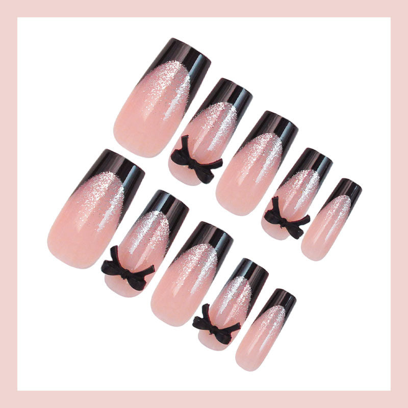 Artificial nail set with elegant glitter accents and bow details Stornfield