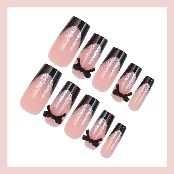 Artificial nail set with elegant glitter accents and bow details Stornfield