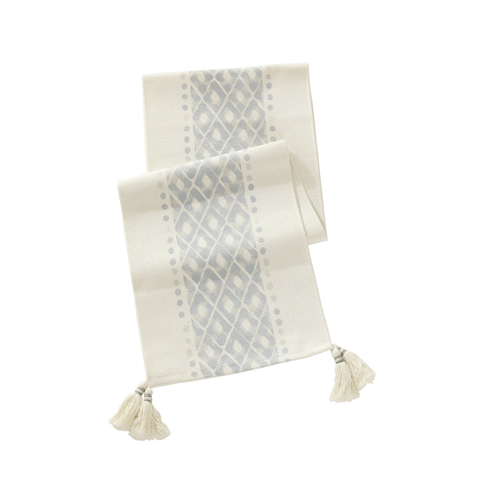 Web table runner made of cotton blend with woven diamond design and tassels