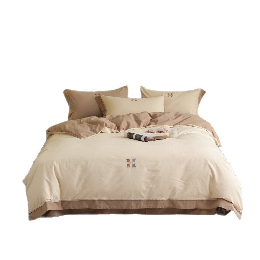 Luxurious cotton satin bedding set with contrasting piped edge and monogram embroidery