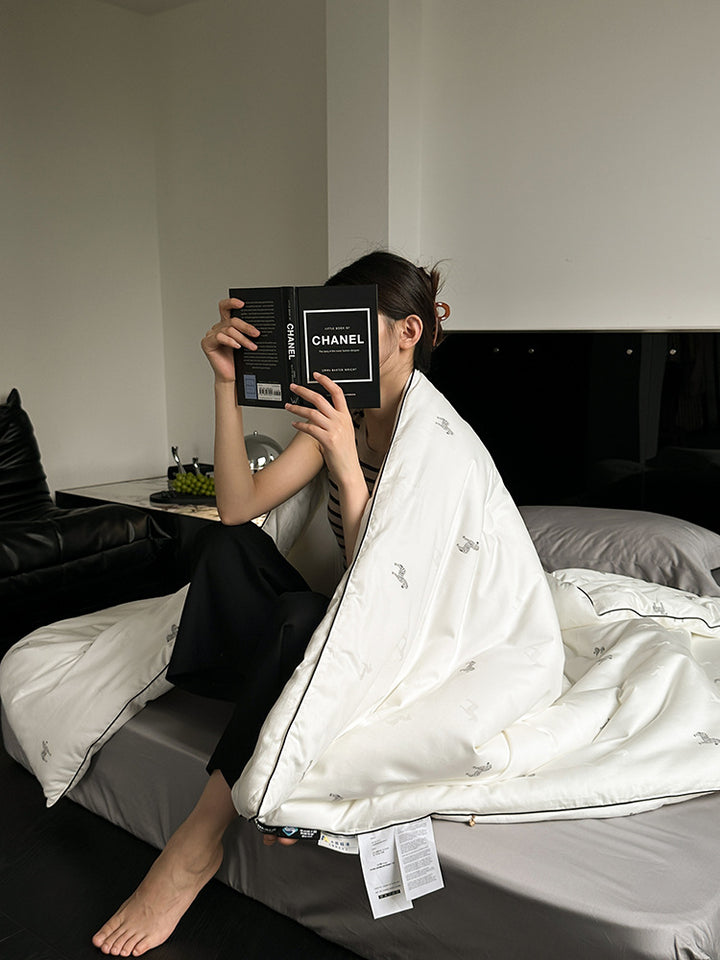 Light-warming cassette comforter with hollow fiber filling and fine tonal embroidery