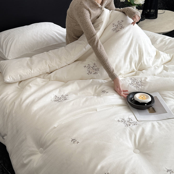 Quilted all-season duvet with floral embroidery and button detailing