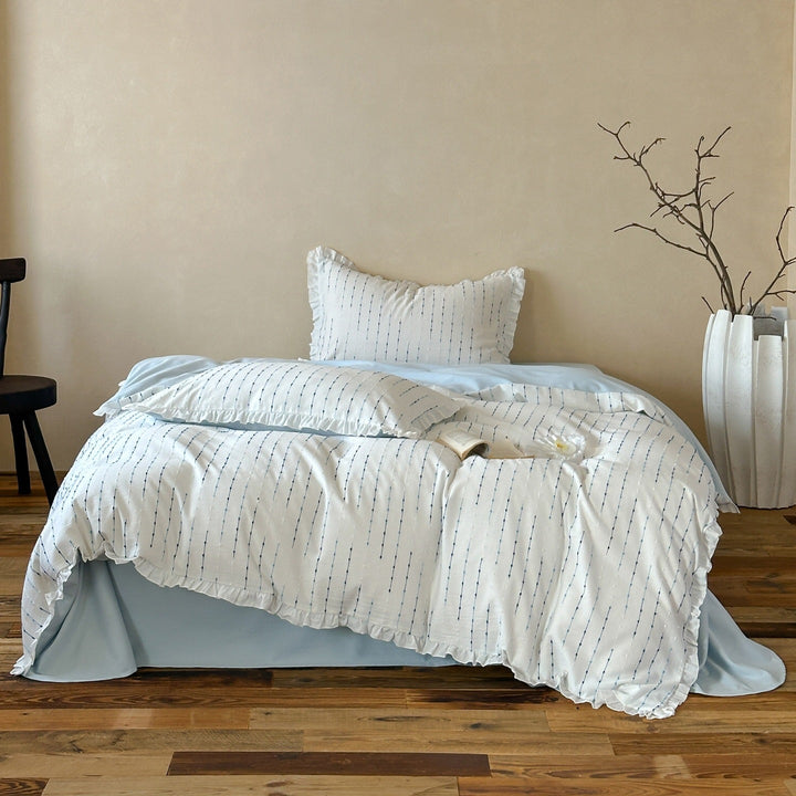 Bedding set made of lightweight cotton muslin with fine line embroidery and ruffled border
