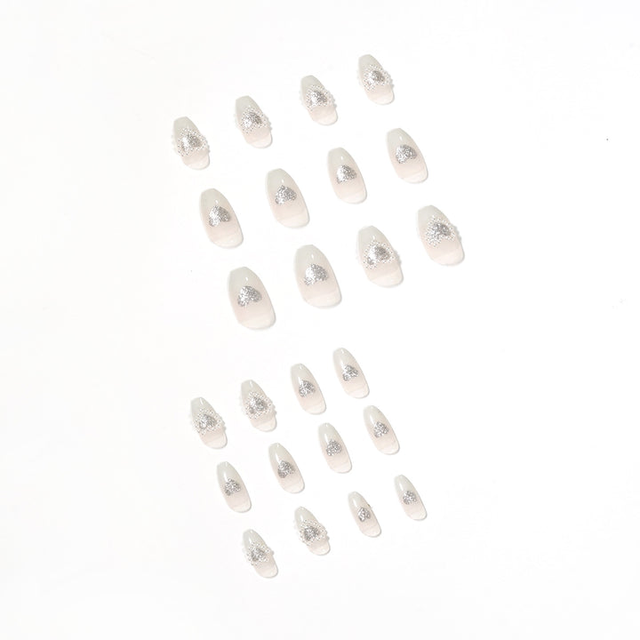 Artificial nail art with heart and rhinestone decorations Stornfield