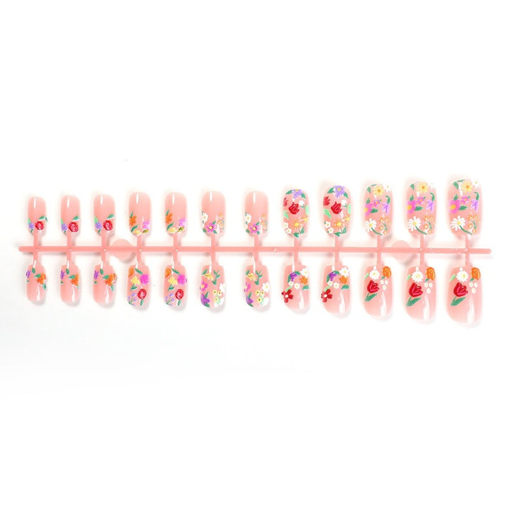 Acrylic nail set with floral motifs and glitter accents Stornfield