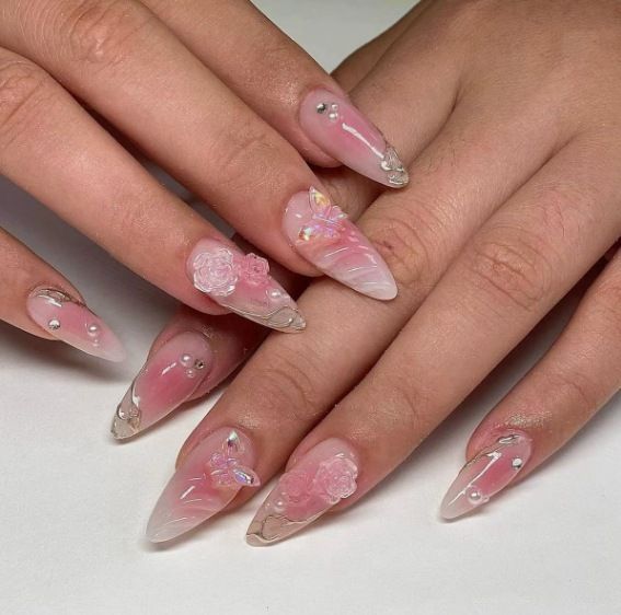 Artificial nail creation with floral 3D details and glitter accents Stornfield