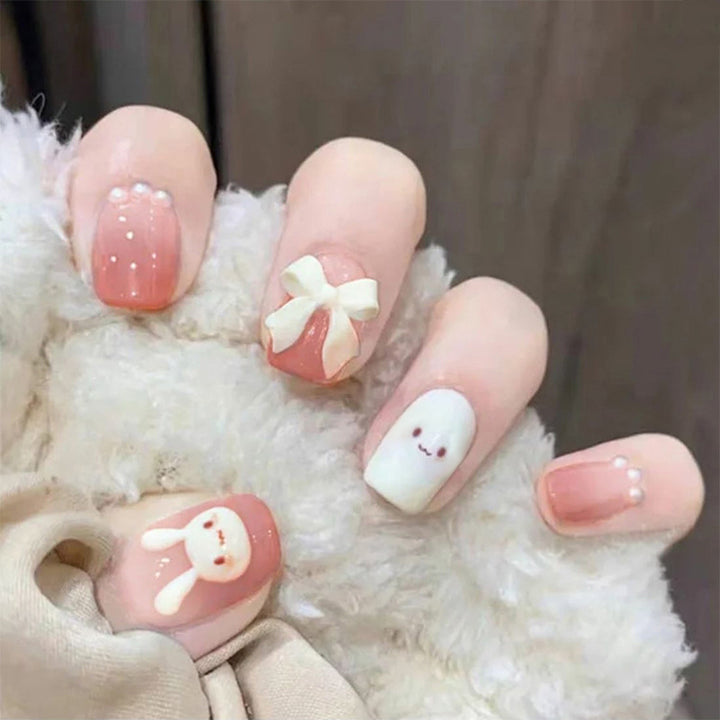 Glamorous artificial nails with heart design and glittering accents Stornfield