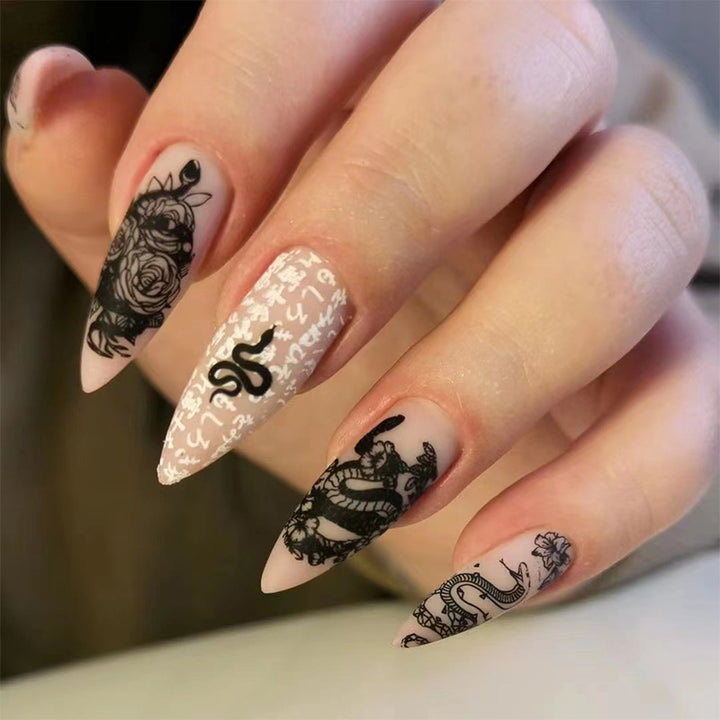 Artful nail extensions in elegant stiletto style with artistic floral and graphic designs Stornfield